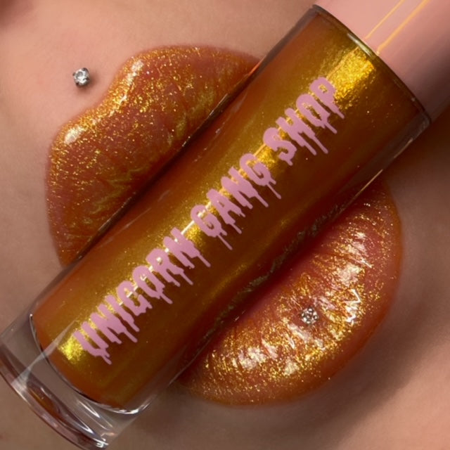 Shimmer gloss in a gold sparkle finish. lightweight non sticky formula. vegan and cruelty free